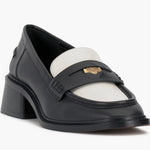 Black and cream colored leather loafer with heel front side profile.
