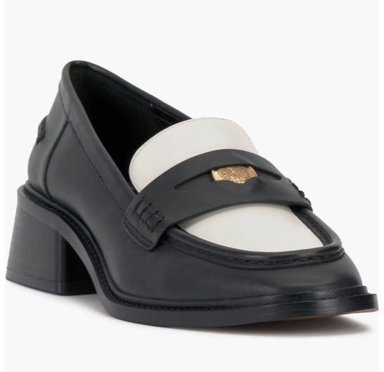 Black and cream colored leather loafer with heel front side profile.