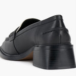 Black and cream colored leather loafer with heel back side view.