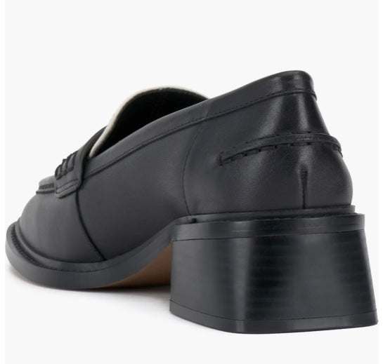 Black and cream colored leather loafer with heel back side view.