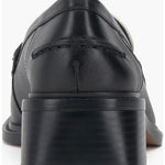 Black and cream colored leather loafer with heel back view.