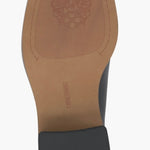 Black and cream colored leather loafer with heel full bottom view.