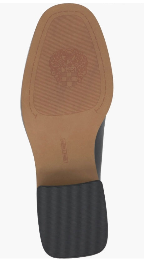 Black and cream colored leather loafer with heel full bottom view.