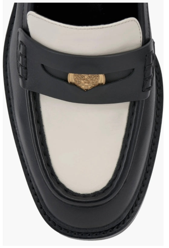 Black and cream colored leather loafer with heel top front view.