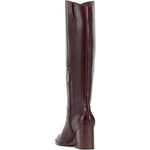 Brown knee-high tall shaft boot with soft round toe and a stacked block heel. Has zippered side closure and elastic inserts on the shaft for improved fit. The boot is lined with fabric and finished on the exterior with a leather-covered welt and rubber outsole side back