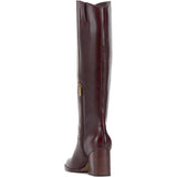 Brown knee-high tall shaft boot with soft round toe and a stacked block heel. Has zippered side closure and elastic inserts on the shaft for improved fit. The boot is lined with fabric and finished on the exterior with a leather-covered welt and rubber outsole side back