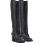 Black knee-high tall shaft boot with soft round toe and a stacked block heel. Has zippered side closure and elastic inserts on the shaft for improved fit. The boot is lined with fabric and finished on the exterior with a leather-covered welt and rubber outsole pair