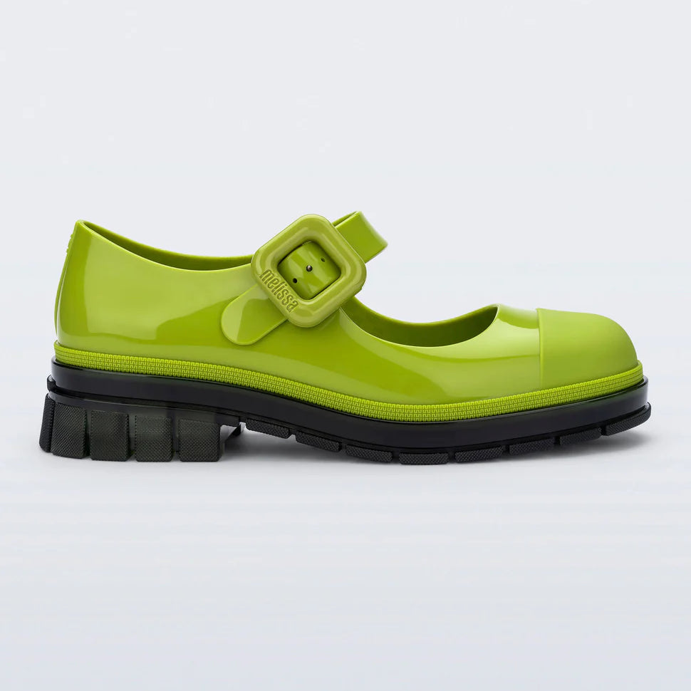 This Mary Jane by Melissa  features a bright green hue, slight heel, fun bubblegum scent, and large buckle detail side profile