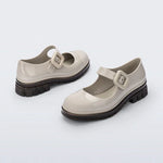 The June Mary Jane by Melissa features a neutral beige hue, slight heel, fun bubblegum scent, and large buckle detail front back side profile