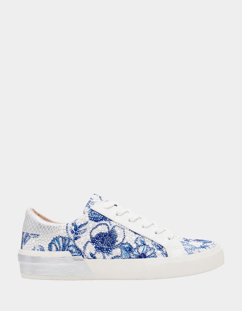 White sneakers with blue floral pattern on a white background
