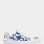 White sneakers with blue floral pattern on a white background