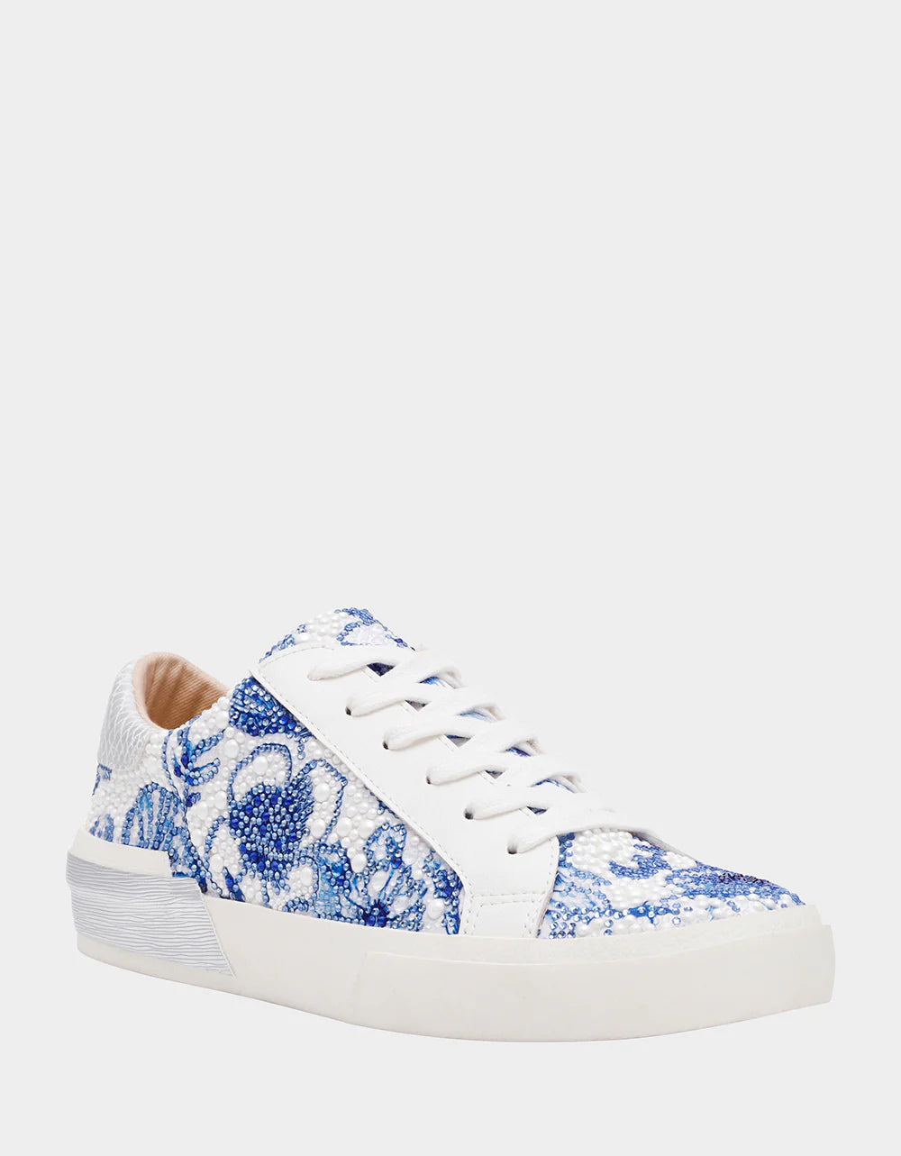 White sneaker with blue floral pattern on a white background