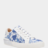 White sneaker with blue floral pattern on a white background