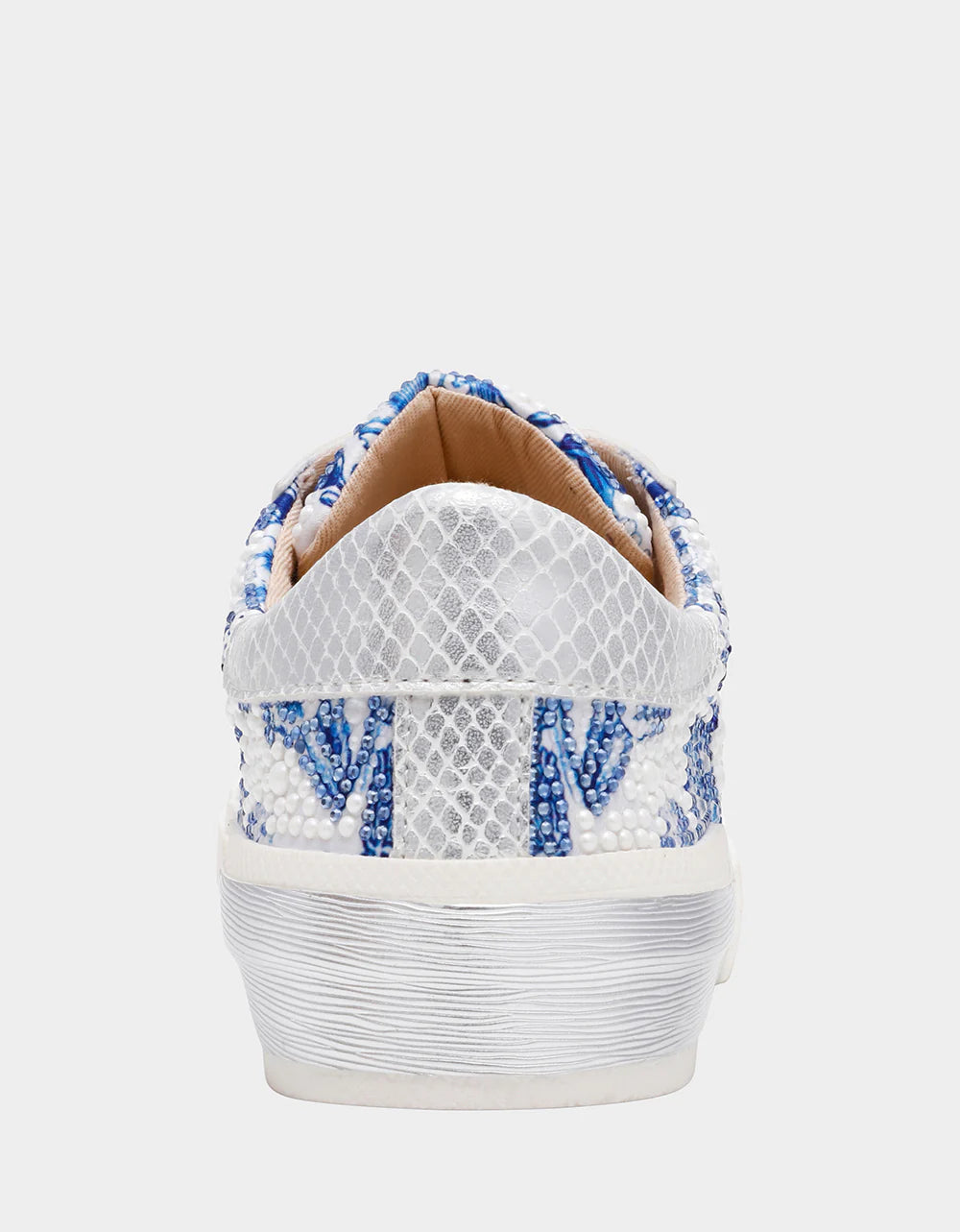 White sneaker with blue floral pattern on a white background