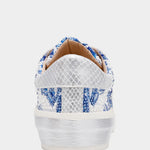 White sneaker with blue floral pattern on a white background