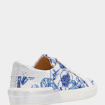 Sneaker with blue floral pattern on a white background