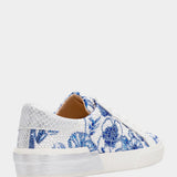 Sneaker with blue floral pattern on a white background