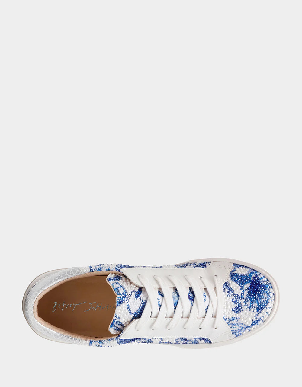 White sneaker with blue floral pattern on a white background