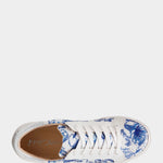 White sneaker with blue floral pattern on a white background