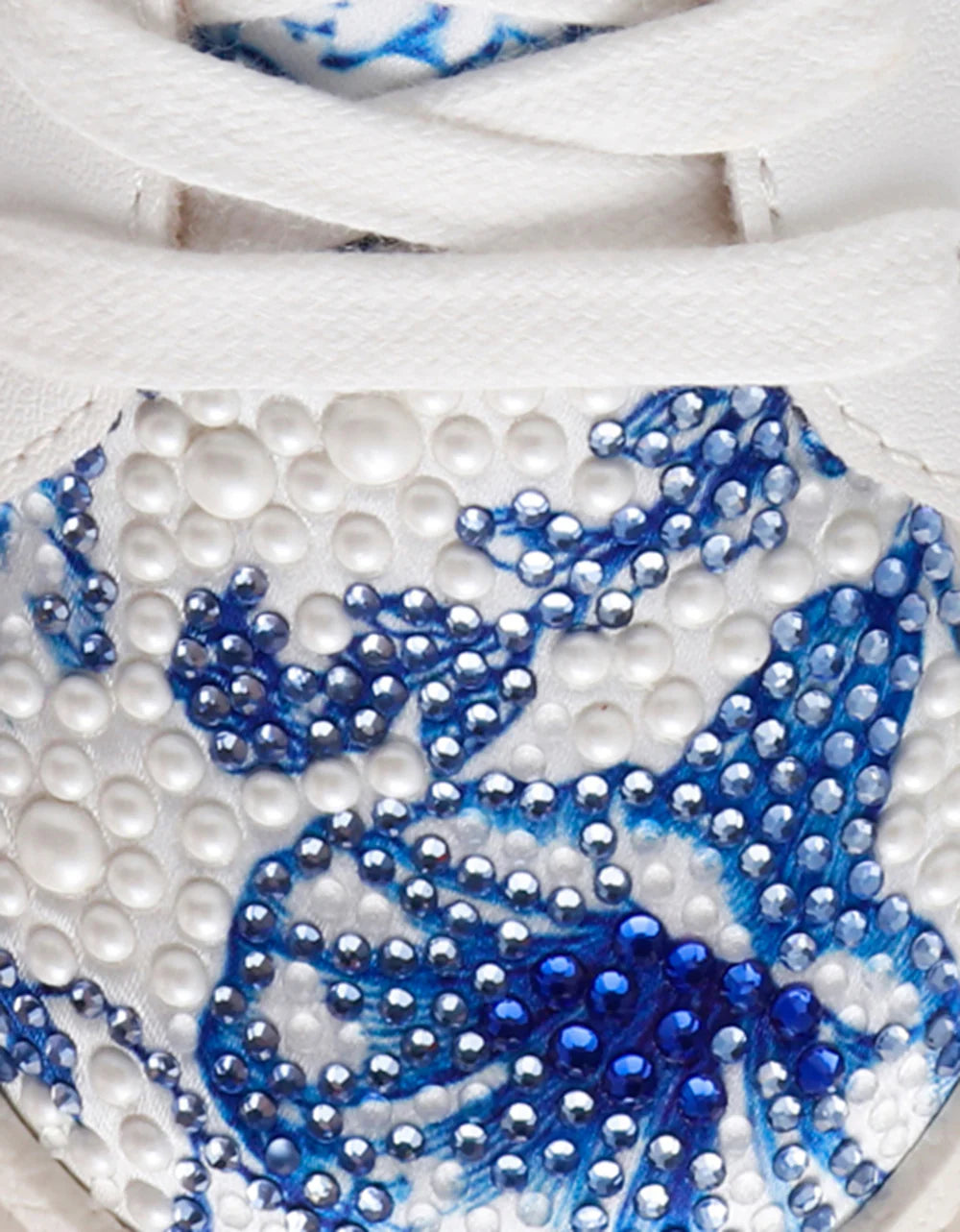 Close-up of a decorative item with blue and white patterns on a white background