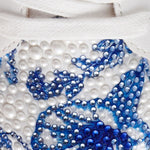 Close-up of a decorative item with blue and white patterns on a white background