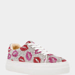 White sneaker with pink and red floral patterns and rhinestones on a white background