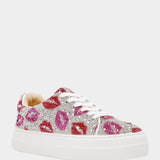 White sneaker with pink and red floral patterns and rhinestones on a white background