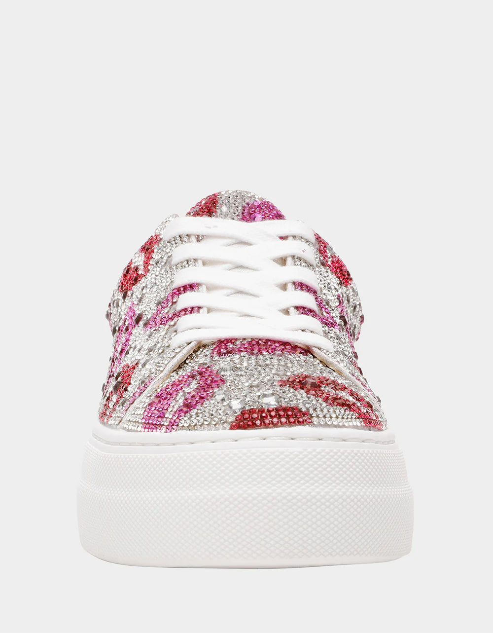 White sneaker with pink and red embellishments on a white background