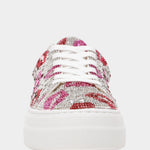 White sneaker with pink and red embellishments on a white background