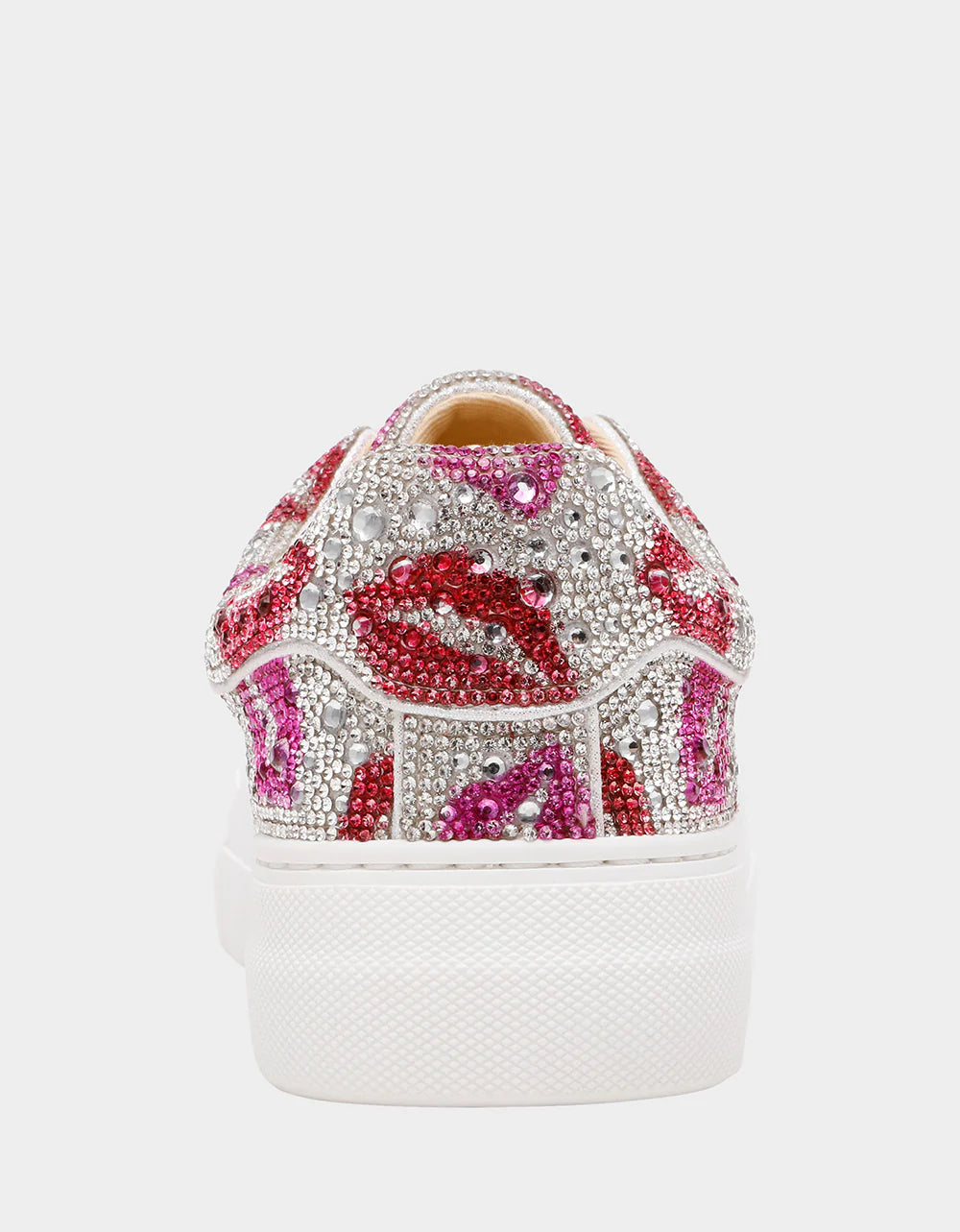 White sneaker with pink and red lip designs and rhinestones on a white background