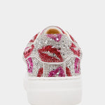 White sneaker with pink and red lip designs and rhinestones on a white background