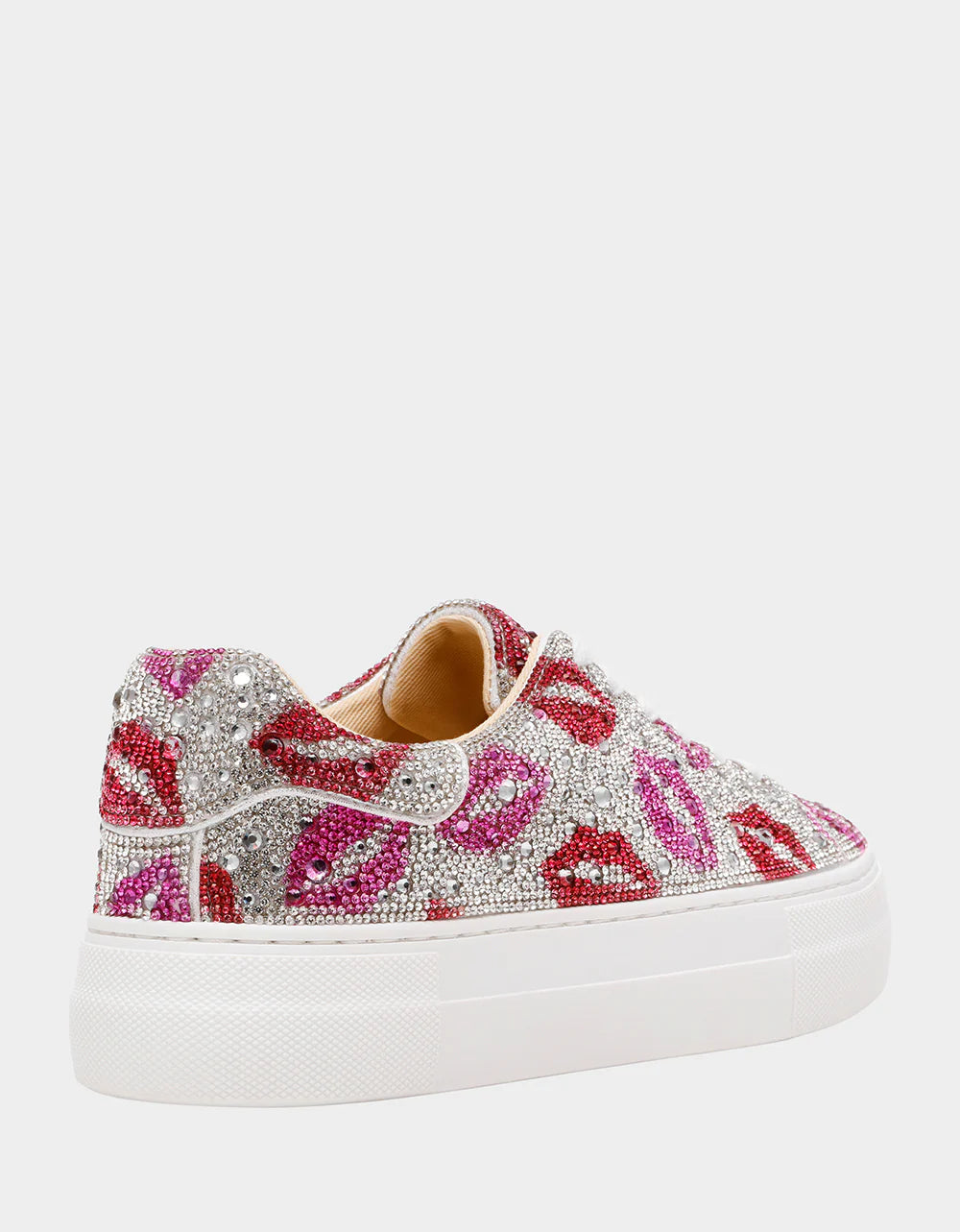Decorative sneaker with pink and silver embellishments on a white background