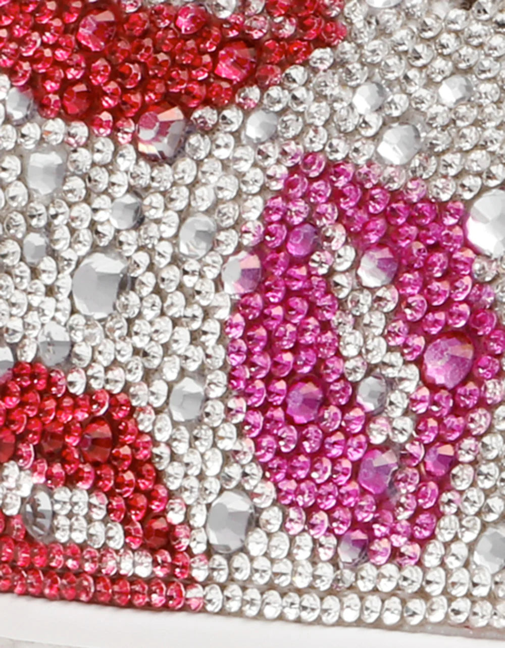 Close-up of a phone case with pink, red, and clear rhinestones.