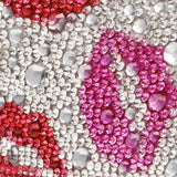 Close-up of a phone case with pink, red, and clear rhinestones.
