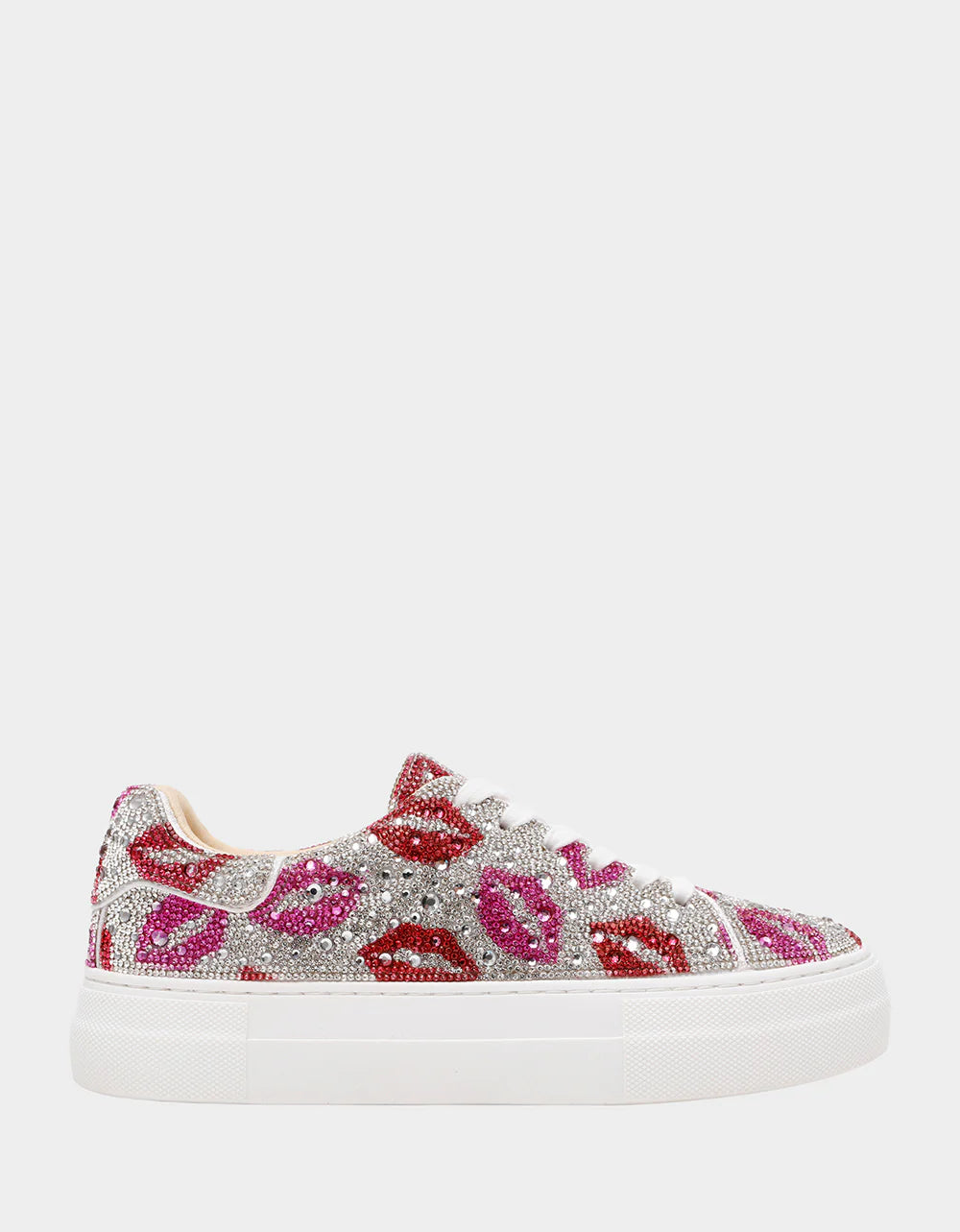 Sneaker with lip print embellishments on a white background