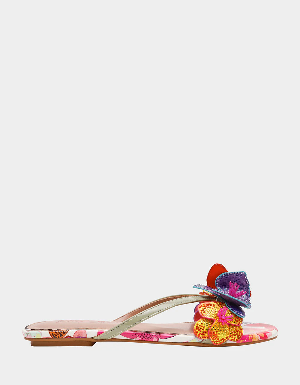 Colorful sandal with gold thong strap and butterfly embellishments close-up