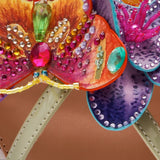 Colorful sandal with gold thong strap and butterfly embellishments detail