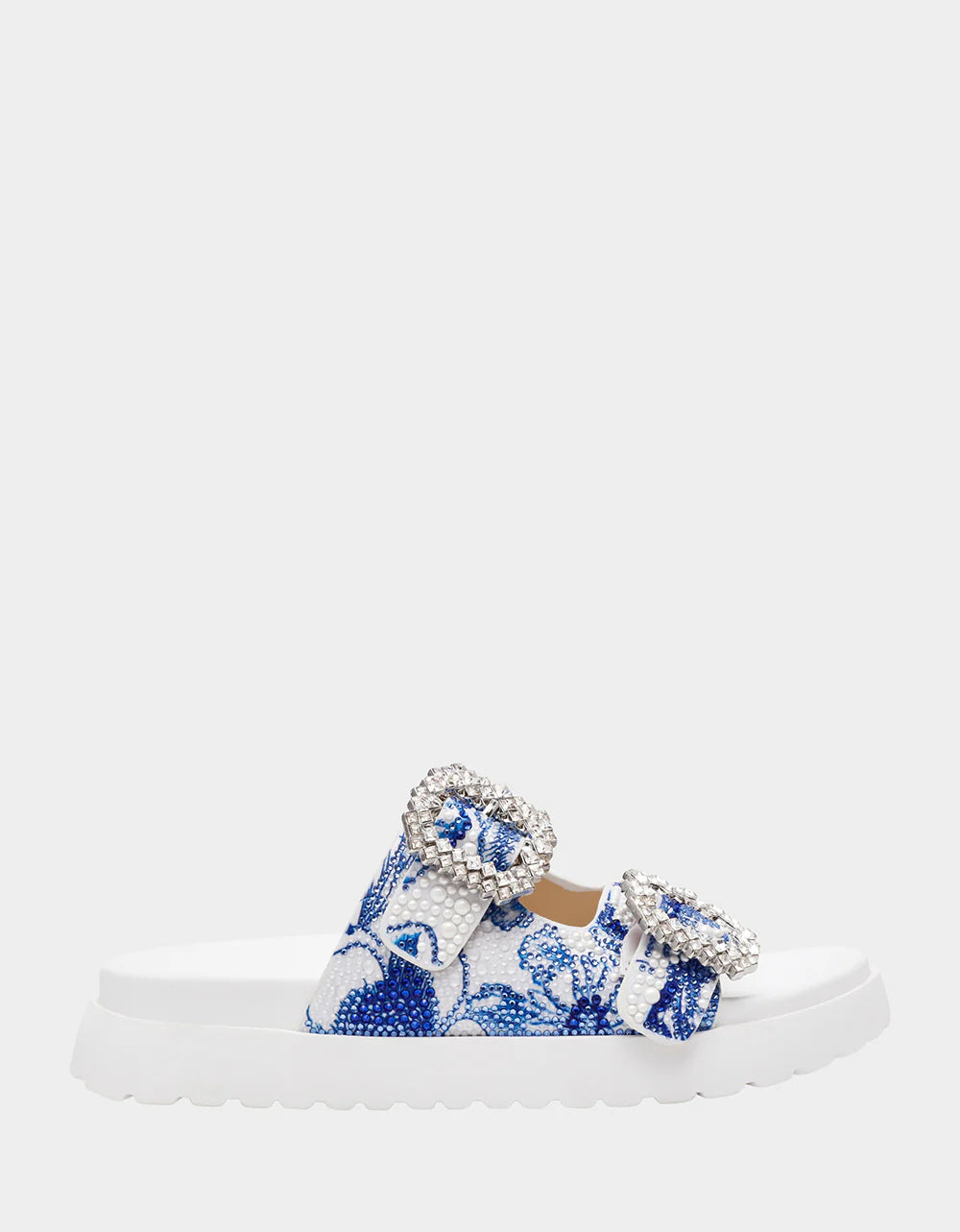 White sandal with blue bejeweled floral pattern and embellishments close-up