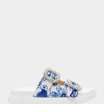 White sandal with blue bejeweled floral pattern and embellishments close-up