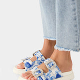 White sandal with blue bejeweled floral pattern and embellishments pair