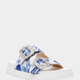 White sandal with blue bejeweled floral pattern and embellishments front view