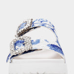 White sandal with blue bejeweled floral pattern and embellishments toe box
