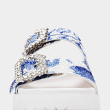 White sandal with blue bejeweled floral pattern and embellishments toe box