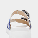 White sandal with blue bejeweled floral pattern and embellishments heel view