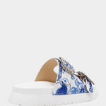 White sandal with blue bejeweled floral pattern and embellishments side view
