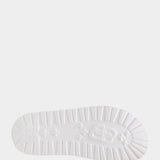 White sandal with blue bejeweled floral pattern and embellishments sole