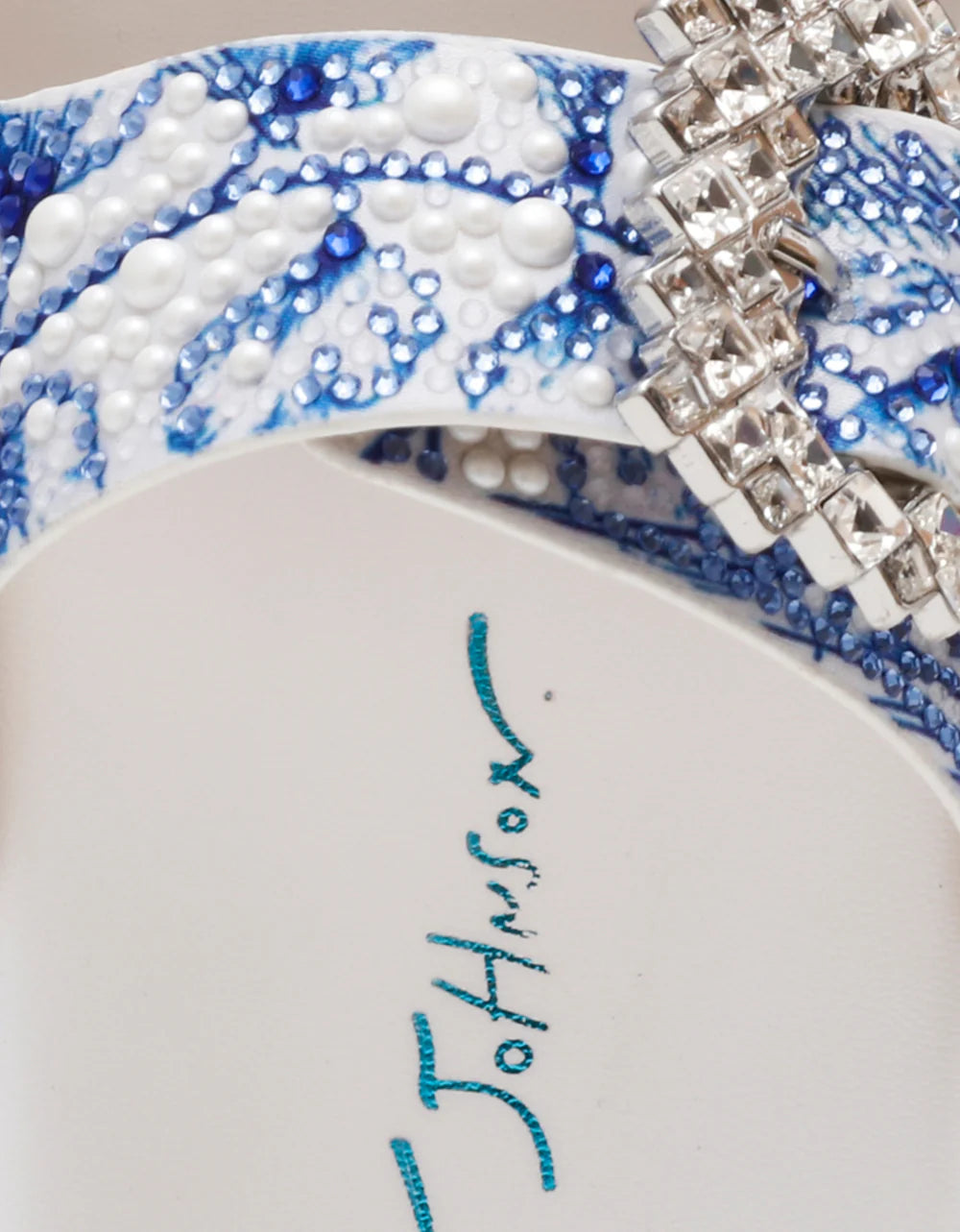 White sandal with blue bejeweled floral pattern and embellishments detail