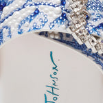 White sandal with blue bejeweled floral pattern and embellishments detail