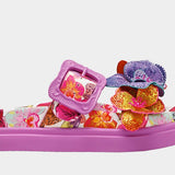 Colorful pink sandal with floral design and embellishments close-up