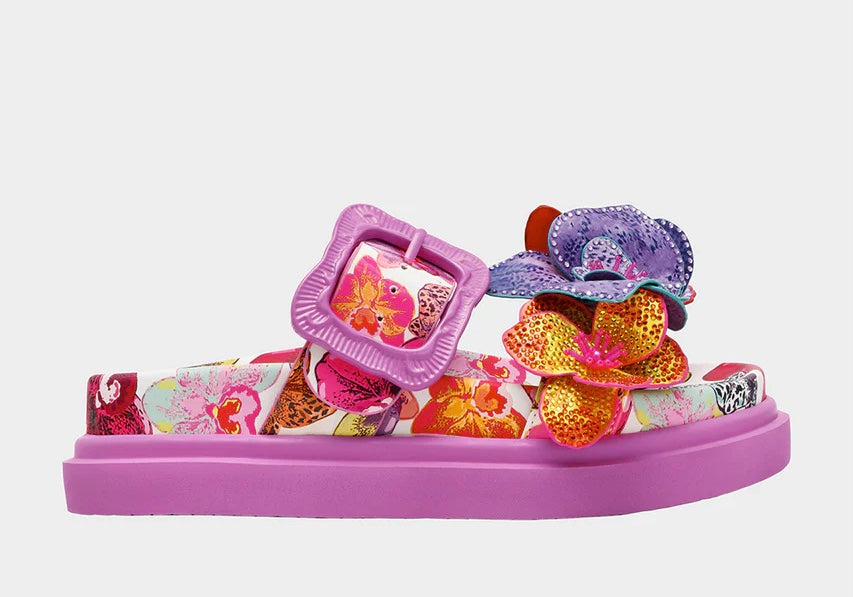 Colorful pink sandal with floral design and embellishments close-up